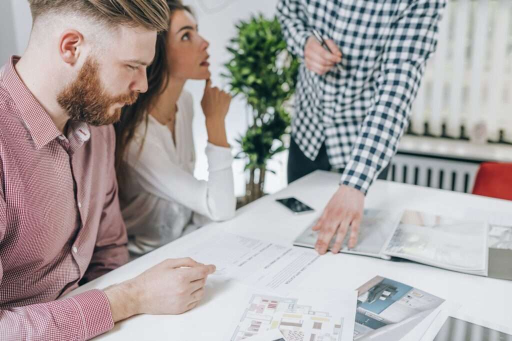 Couple in Real-Estate Agency Talking to Real Estate Agent