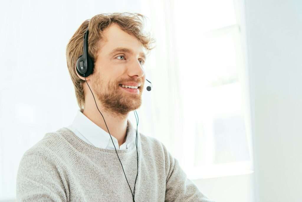 handsome bearded operator in brokers agency in headset