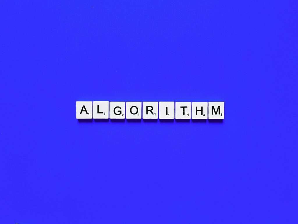 SEO Hannover - Das Bild zeigt das Wort „ALGORITHM“, das aus einzelnen weißen Buchstabenkacheln mit schwarzen Buchstaben besteht, die in einer geraden Linie auf einem blauen Hintergrund angeordnet sind und an die Präzision und Ordnung eines Google-Algorithmus erinnern. Local SEO Agentur Hannover.