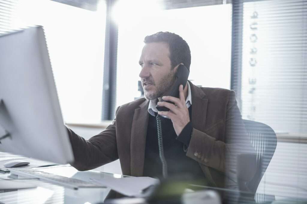 Businessman talking on phone in office