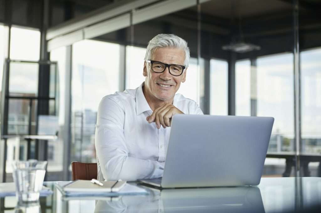 Businessman working in office, using laptop