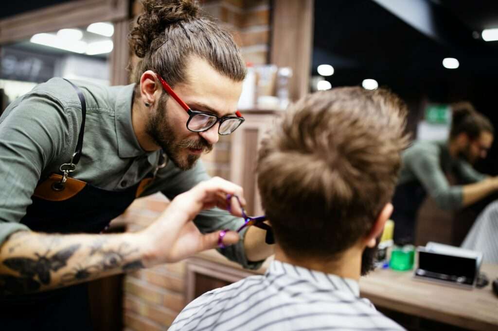 Client during beard and moustache grooming in barber shop