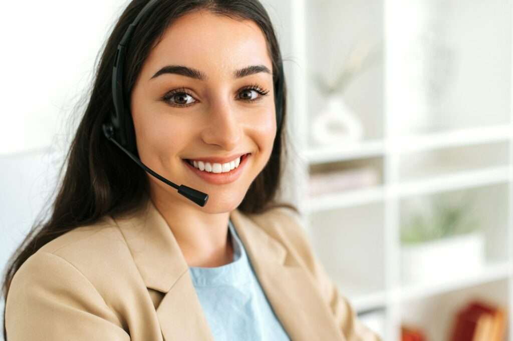 Close-up of arabian or indian pretty woman, call center operator with headset, working on support