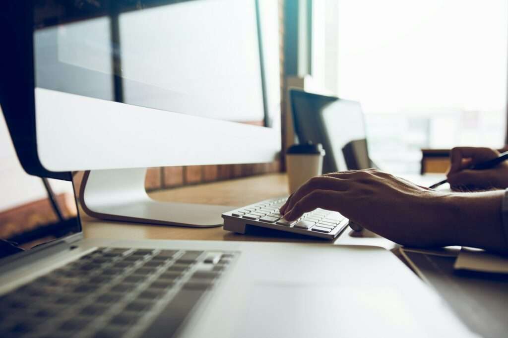 Close up of hands contemporary website developer man typing and writing code for program website.