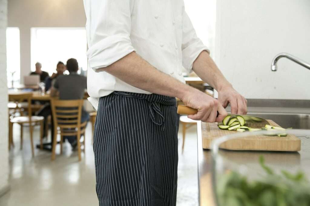 Cook of a bistro preparing food in the kitchen