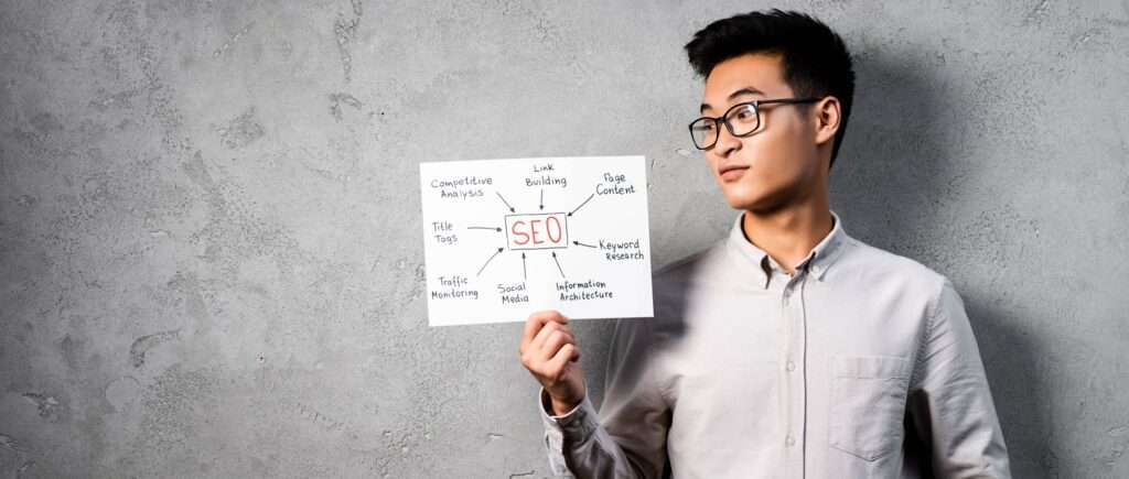 panoramic shot of asian seo manager holding and looking at paper with concept words of seo