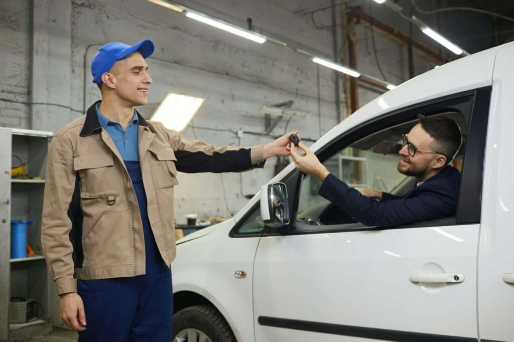 Repairman Giving Keys To Happy Client