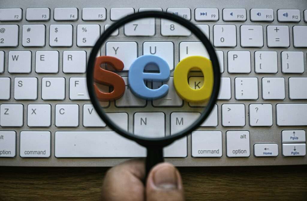 Search engine optimization concept. A hand holding magnifying glass magnify a word seo