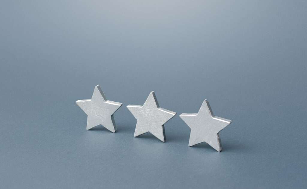 Three gray stars. Rating evaluation concept. Service quality. Buyer feedback. High satisfaction