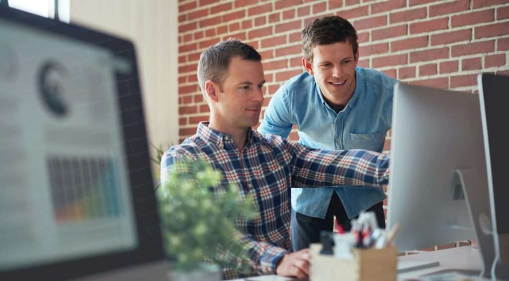 two businessman using computer office team leader man training intern colleagues working together i