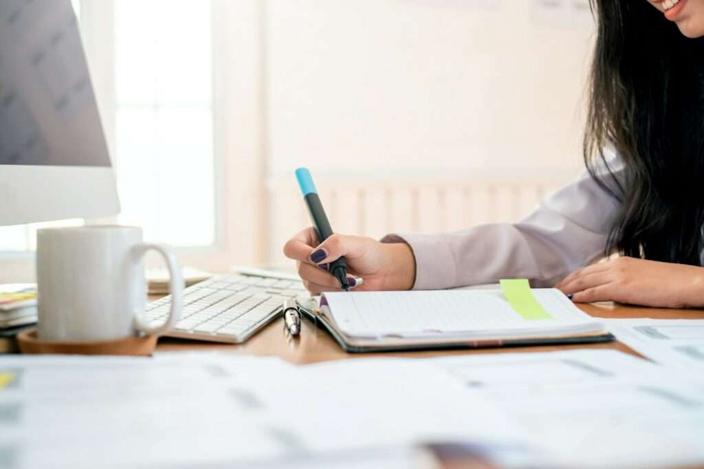 Designer woman drawing a website outline and website ux app development on mobile phone.