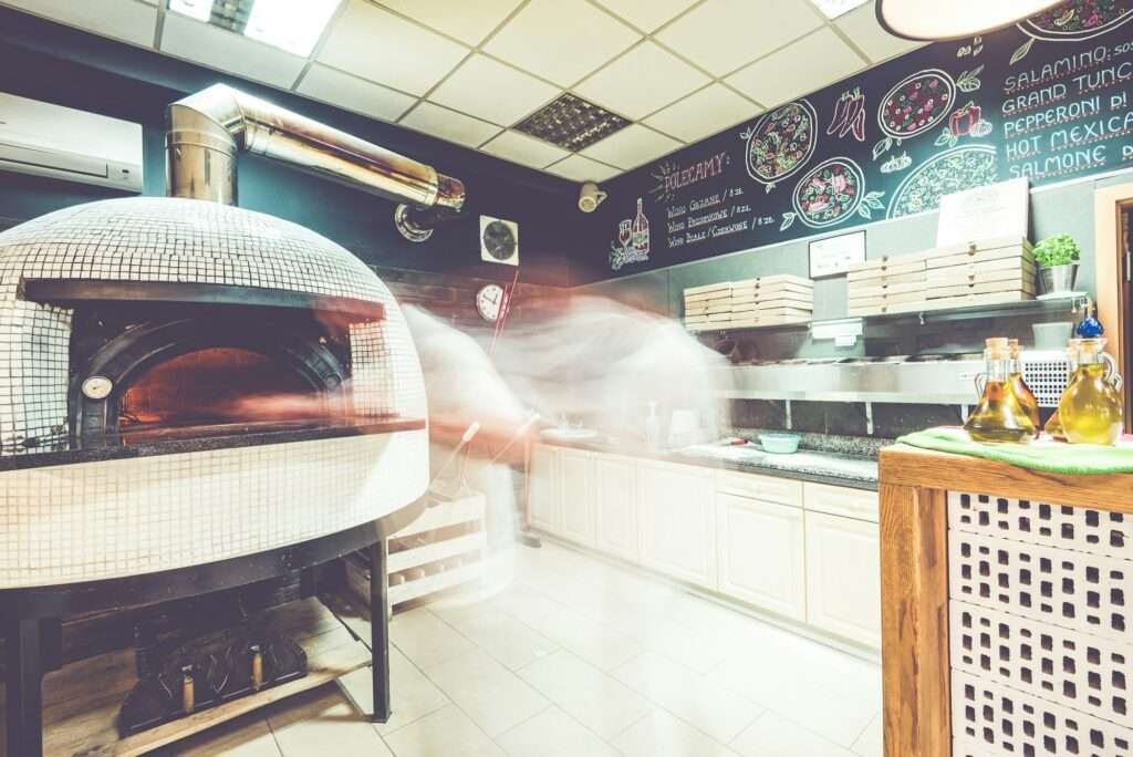 Fast moving pizzaioilo chef at local pizzeria