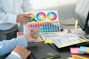 graphic designer team working on web design using color swatches editing artwork using tablet and a