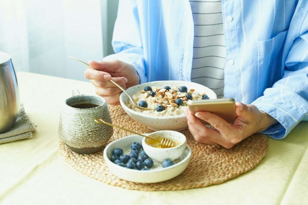 Morning breakfast and surfing internet on mobile