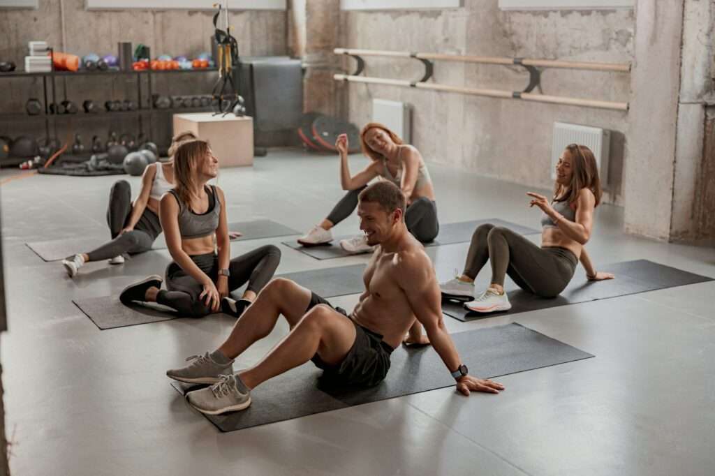 Personal trainer with his clients in gym