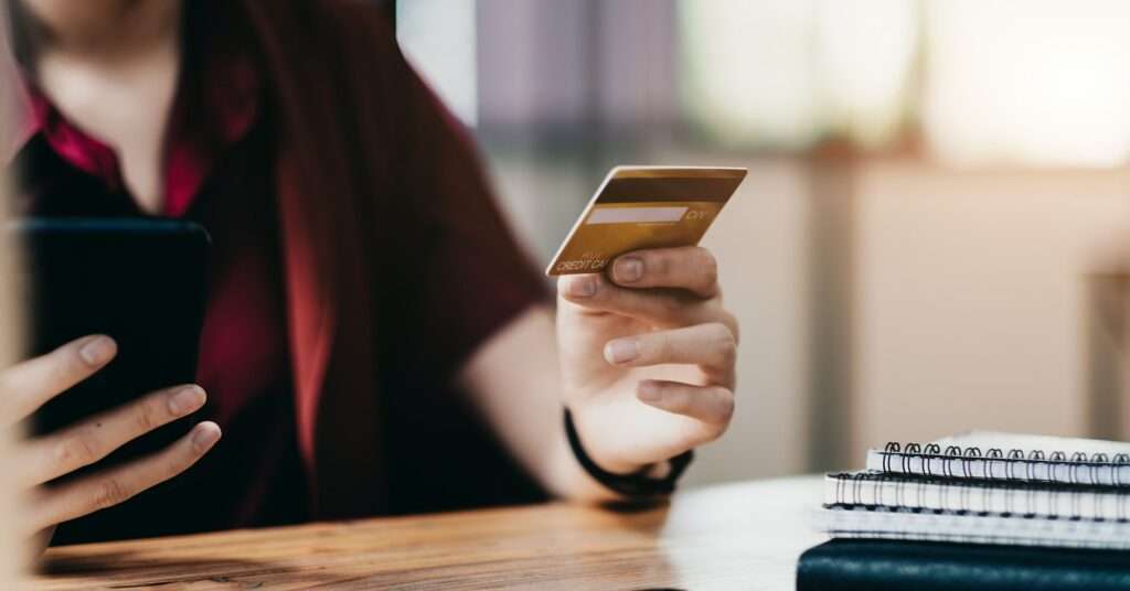 Woman using credit card and mobile phone for online shopping and internet payment via mobile banking